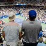 Tennis fans inside a stadium during the US Open; generic tournament atmosphere, not a photo from the September 7, 2026 matches.