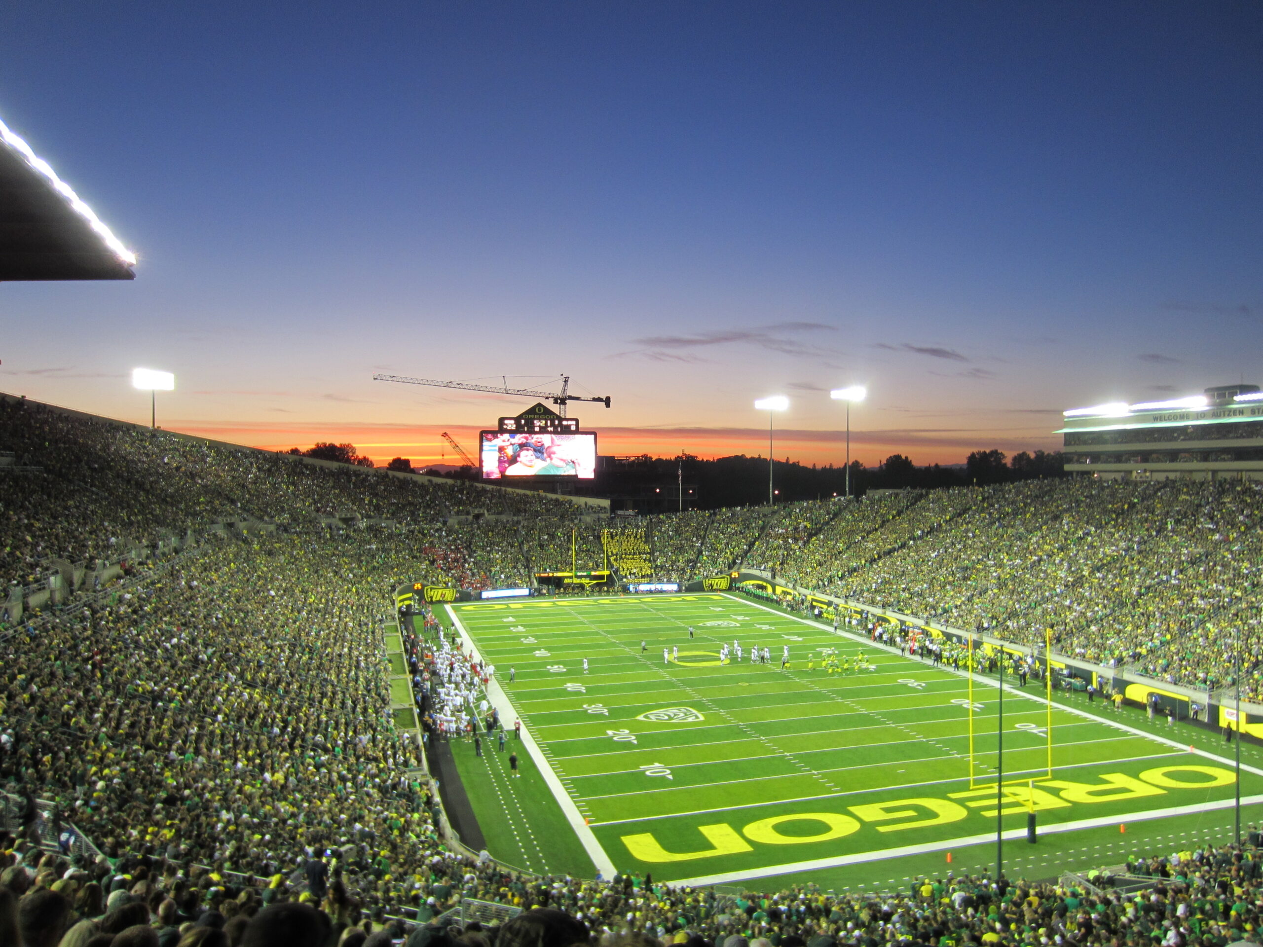 Autzen Stadium filled with Oregon Ducks fans at sunset