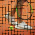 Tennis racket and balls on a court illustrating beginner racket selection