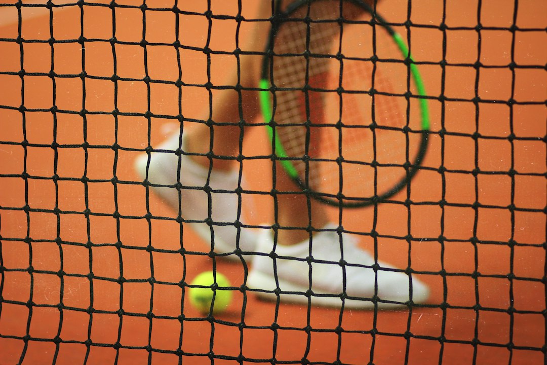 Tennis racket and balls on a court illustrating beginner racket selection
