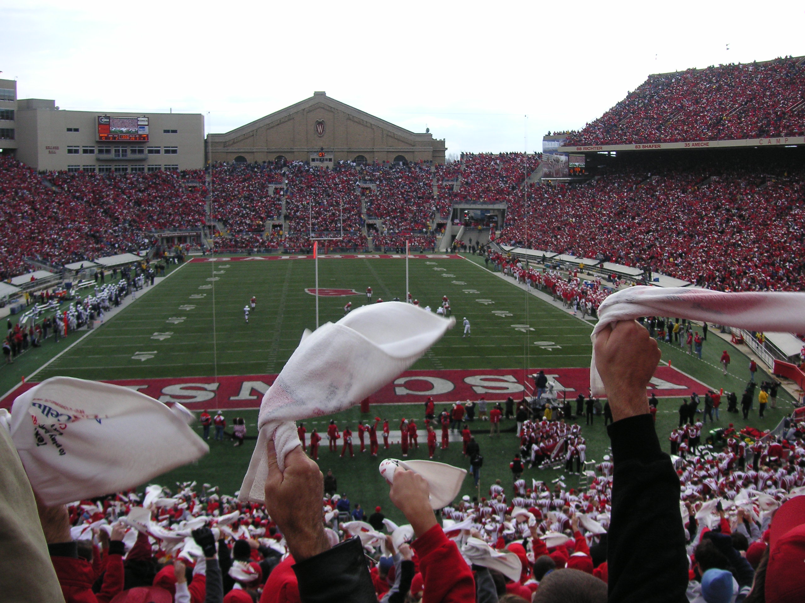 Wisconsin fans waving towels inside Camp Randall Stadium during a football game