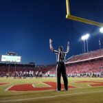 College football player on the field illustrating the College Football Playoff