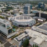 A large sports arena and surrounding cityscape used as generic college sports imagery