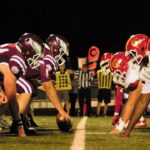 American football players at the line of scrimmage illustrating offensive and defensive positions