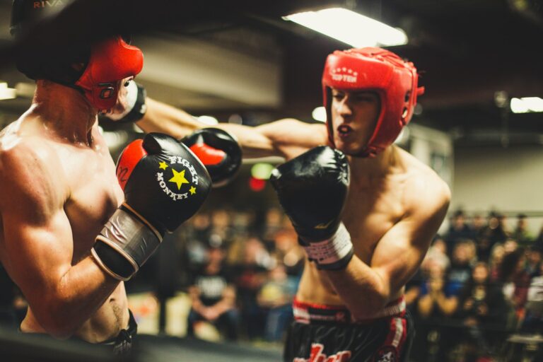 Two boxers competing in a boxing ring