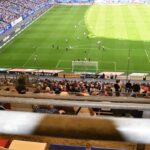Soccer match on a football field, used as generic imagery for a promotion and relegation explainer