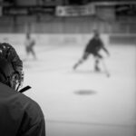 Ice hockey players competing during a game on an indoor rink