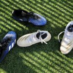 Sports shoes and cleats on grass illustrating surface and traction choices