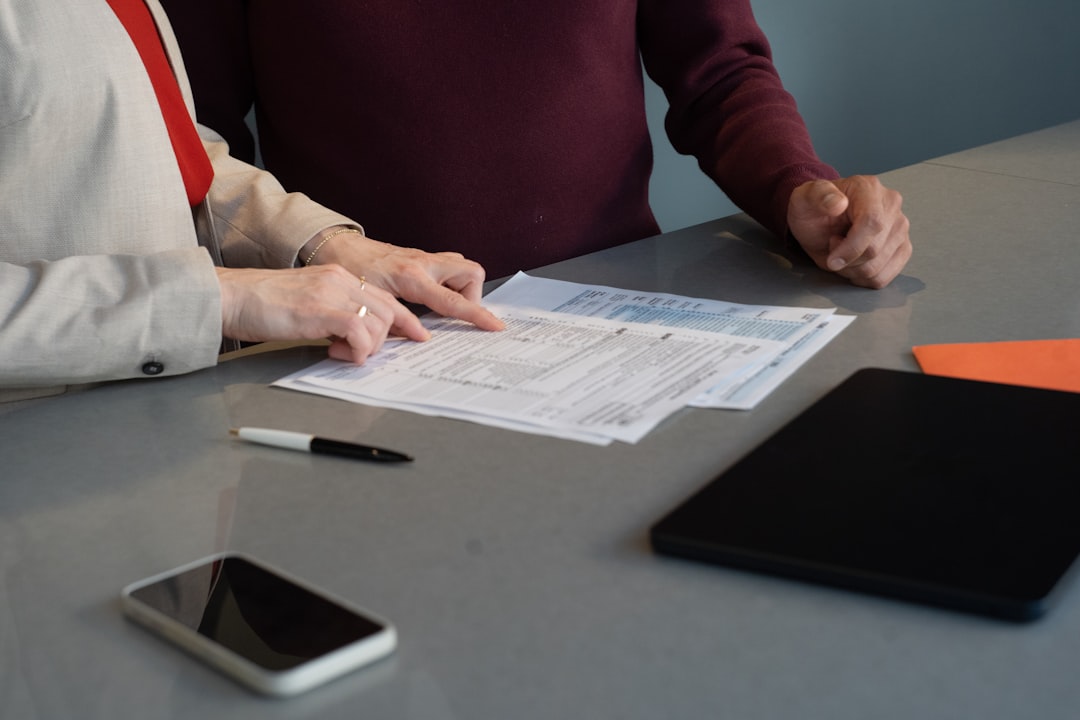 Professionals reviewing paperwork during a client meeting