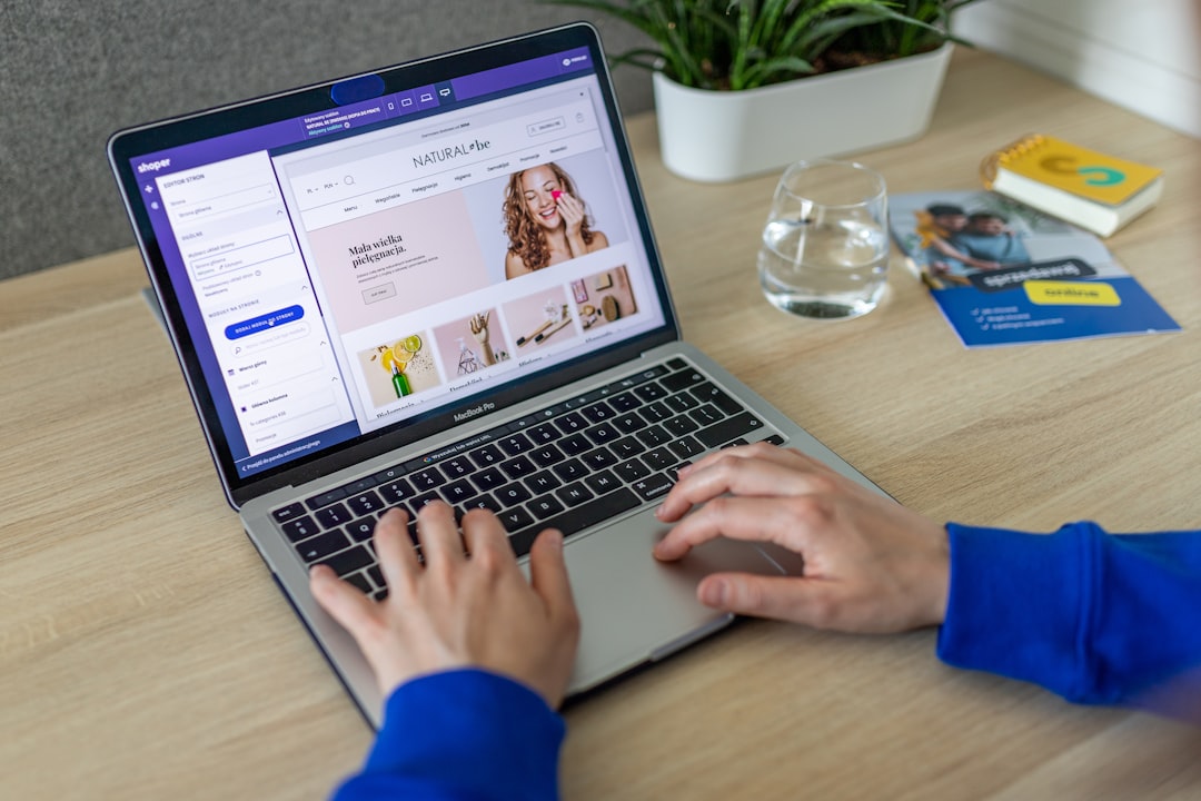 Hands editing an online store on a laptop