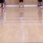Women playing basketball on an indoor court; generic women’s basketball image, not a specific WNBA game.