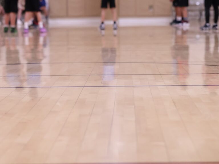Women playing basketball on an indoor court; generic women’s basketball image, not a specific WNBA game.