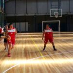 Women playing basketball on an indoor court; generic basketball image, not an NBA or WNBA game photo.